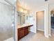 Bathroom featuring tiled shower and double vanity with stylish mirrors and light fixtures at 2145 Plantation Oak Dr, Orlando, FL 32824