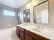 Bathroom featuring a double vanity, stylish mirrors and a shower/tub combo at 2145 Plantation Oak Dr, Orlando, FL 32824