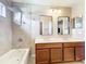 Bathroom featuring a double vanity, stylish mirrors and a tiled shower/tub combo at 2145 Plantation Oak Dr, Orlando, FL 32824