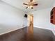 Bedroom with dark wood floors, ceiling fan, and view into the on-suite bathroom at 2145 Plantation Oak Dr, Orlando, FL 32824