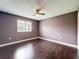 Bedroom featuring wood floors, a ceiling fan, and a window at 2145 Plantation Oak Dr, Orlando, FL 32824