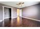 Bedroom featuring wood floors, a ceiling fan, and a closet at 2145 Plantation Oak Dr, Orlando, FL 32824