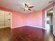 Bedroom featuring hardwood floors and open closet and hall access at 2145 Plantation Oak Dr, Orlando, FL 32824