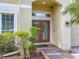 Close-up of front door with glass panes, showing brick walkway and manicured landscaping at 2145 Plantation Oak Dr, Orlando, FL 32824