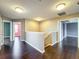Spacious hallway features hardwood floors and neutral walls, connecting various rooms in the home at 2145 Plantation Oak Dr, Orlando, FL 32824
