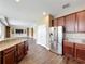 Open kitchen featuring granite countertops, stainless steel appliances, and dark wood cabinets at 2145 Plantation Oak Dr, Orlando, FL 32824