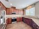 Modern kitchen with stainless steel appliances, granite countertops, and wood cabinets at 2145 Plantation Oak Dr, Orlando, FL 32824