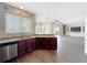 Open kitchen layout overlooking living room, with granite counters and stainless steel dishwasher at 2145 Plantation Oak Dr, Orlando, FL 32824