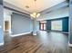 Open-concept living area featuring dark wood floors, neutral walls, and modern lighting fixtures at 2145 Plantation Oak Dr, Orlando, FL 32824