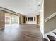 Open-concept living room with sliding doors to an outdoor patio and a decorative wall at 2145 Plantation Oak Dr, Orlando, FL 32824