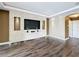 Bright living room featuring a stylish entertainment center and hardwood floors at 2145 Plantation Oak Dr, Orlando, FL 32824