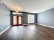 Spacious living room with gray walls, dark wood floors, and a double door entryway at 2145 Plantation Oak Dr, Orlando, FL 32824