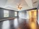 Spacious main bedroom showcases tray ceiling, hardwood floors and natural light from the two windows at 2145 Plantation Oak Dr, Orlando, FL 32824
