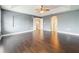 Large main bedroom with high ceilings, hardwood floors, neutral colors, and hallway views create an open and airy feel at 2145 Plantation Oak Dr, Orlando, FL 32824