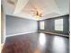 A spacious main bedroom features a tray ceiling, ceiling fan and beautiful hardwood floors at 2145 Plantation Oak Dr, Orlando, FL 32824