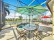 Screened-in pool featuring a relaxing waterfront view, lush landscaping, and a basketball court at 2145 Plantation Oak Dr, Orlando, FL 32824