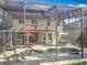 Backyard pool and patio area, fully screened, with comfortable seating and outdoor dining spaces at 2145 Plantation Oak Dr, Orlando, FL 32824