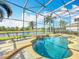 Inviting screened pool with spa and waterfall feature overlooking a tranquil canal and landscaped surroundings at 2145 Plantation Oak Dr, Orlando, FL 32824