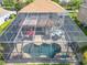 Aerial view of a screened-in pool area with outdoor seating and lush landscaping at 2145 Plantation Oak Dr, Orlando, FL 32824
