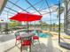 Screened-in pool area with patio furniture and a picturesque view of the water at 2145 Plantation Oak Dr, Orlando, FL 32824