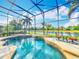 Beautiful screened pool area with waterfront views, featuring a relaxing spa and charming patio furniture at 2145 Plantation Oak Dr, Orlando, FL 32824