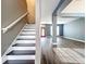Staircase to the second level with wood floors and grey walls at 2145 Plantation Oak Dr, Orlando, FL 32824