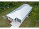 Aerial view featuring the metal roof, attached garage, and landscaped areas at 2259 3Rd Ave, Deland, FL 32724