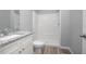 Modern bathroom featuring a granite countertop, white cabinets, toilet, shower, and tile floors at 2259 3Rd Ave, Deland, FL 32724