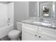 Modern bathroom with granite countertop, white cabinets, toilet, tub, and shower at 2259 3Rd Ave, Deland, FL 32724