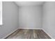 Minimalist bedroom featuring light grey walls, wood-look floors, and a window offering natural light at 2259 3Rd Ave, Deland, FL 32724