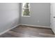 Light and airy bedroom with grey walls, wood-look floors, a white door, and a window at 2259 3Rd Ave, Deland, FL 32724