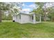 Side view of a white house with a covered porch and green grass at 2259 3Rd Ave, Deland, FL 32724
