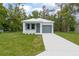 Charming single-Gathering home with a well-maintained lawn and a gray front door and garage at 2259 3Rd Ave, Deland, FL 32724