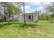 Beautiful home with a white exterior and well-maintained lawn in a lush, green setting at 2259 3Rd Ave, Deland, FL 32724