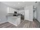 Modern kitchen with white cabinets, stainless steel appliances, and granite countertops at 2259 3Rd Ave, Deland, FL 32724