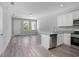 Bright, open living area featuring wood-look floors and a modern kitchen with stainless appliances at 2259 3Rd Ave, Deland, FL 32724
