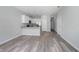 Open-concept living space featuring wood-look floors and a kitchen with granite countertops at 2259 3Rd Ave, Deland, FL 32724