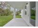 Covered porch with concrete flooring and view of the lush backyard at 2259 3Rd Ave, Deland, FL 32724