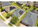 Aerial view of single Gathering home, solar panels, and well-maintained lawns at 2331 Kennington Cv, Deland, FL 32724