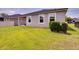 Well-maintained backyard showcasing the home's exterior with green lawn space at 2331 Kennington Cv, Deland, FL 32724