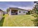 Large backyard with a covered patio, grill, and ample green space at 2331 Kennington Cv, Deland, FL 32724