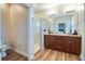 Bright bathroom boasts a double vanity, granite countertops, and a glass-enclosed shower at 2331 Kennington Cv, Deland, FL 32724