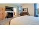 Comfortable bedroom featuring a television, dresser, and ensuite bathroom entrance at 2331 Kennington Cv, Deland, FL 32724