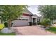 Charming home featuring a brick driveway, well-manicured landscaping, and a two-car garage at 2331 Kennington Cv, Deland, FL 32724