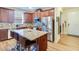 Open kitchen featuring a large island, granite countertops, and stainless steel appliances at 2331 Kennington Cv, Deland, FL 32724