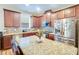 Kitchen with granite countertops, island with seating, and stainless steel refrigerator at 2331 Kennington Cv, Deland, FL 32724