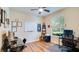 Bright office space with wood-look flooring, a ceiling fan, and a large window at 2331 Kennington Cv, Deland, FL 32724
