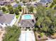 Aerial view of community clubhouse and pool featuring ample lounge seating and mature landscaping at 2331 Kennington Cv, Deland, FL 32724