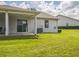 This home features a cozy covered patio and sliding glass doors to the backyard at 2503 Se 18Th Cir, Ocala, FL 34471