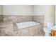 Large bathtub with brown tile and a white toilet, as well as a vanity at 2503 Se 18Th Cir, Ocala, FL 34471
